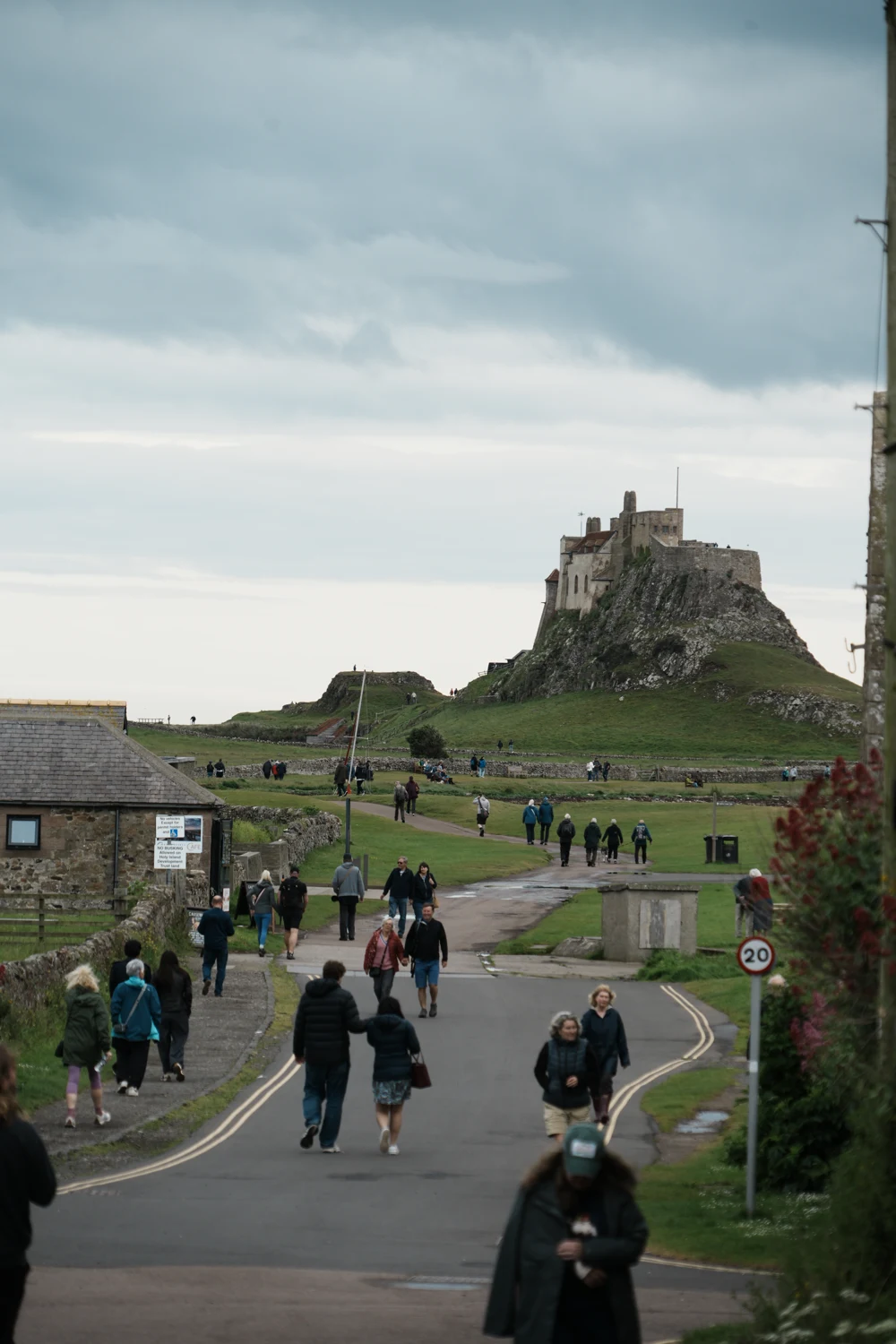 Visitors following the path towards Lindisfarne Castle